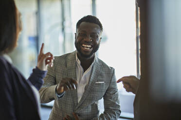 Laughing business people meeting in hotel lobby - ZEDF02996