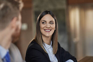 Portrait of a smiling businesswoman looking at colleague - ZEDF03045