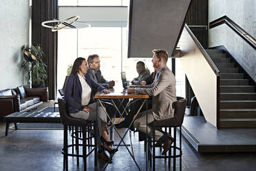 Business people having a meeting in hotel lobby - ZEDF03052