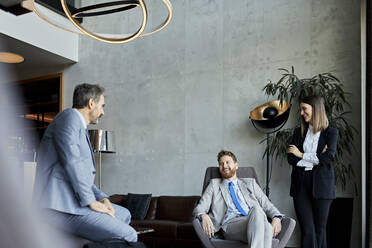 Business people having a meeting in hotel lobby - ZEDF03077