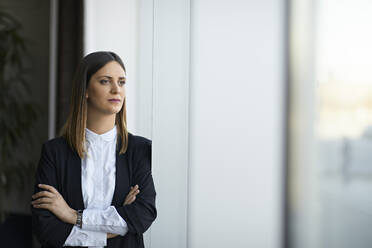 Portrait of a serious businesswoman looking out of window - ZEDF03078