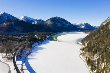 Germany, Bavaria, Lenggries, Drone view of elevated highway crossing Sylvenstein Reservoir in winter - LHF00781