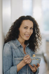 Beautiful woman having healthy breakfast, eating granola - JOSEF00080