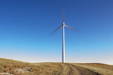 Wind Turbine in Colorado against blue sky - CAVF75609