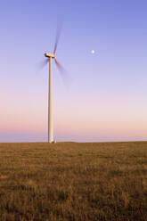 Windturbine in Bewegung gegen blauen Himmel mit Mond - CAVF75625