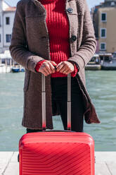 Close up of a woman holding luggage travel bag - CAVF75702