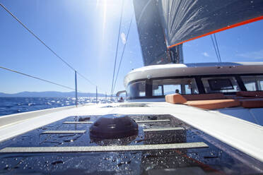 Onboard a catamaran enjoying a beautiful sunny day during a cruise. - CAVF75723
