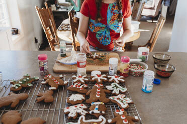 Girls Hands putting Sprinkles on Christmas Cookies - CAVF75835