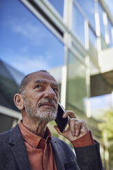 Senior businessman in the city, talking on the phone - MCF00582