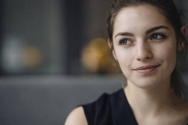 Portrait of smiling young woman looking at distance - KNSF07640