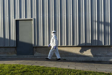 Female scientist wearing protective suit and mask - ERRF02729