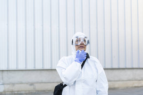 Female scientist wearing protective suit and mask - ERRF02739