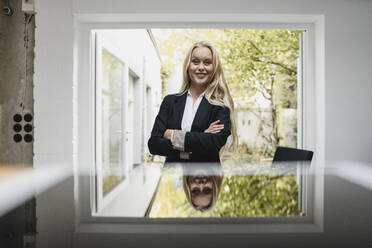 Portrait of a confident blond young businesswoman - GUSF03381