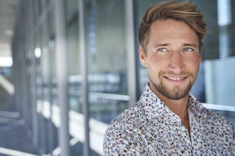 Portrait of smiling young man wearing patterned shirt stock photo
