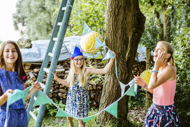 Girls decorating the garden for a birthday party - SODF00655