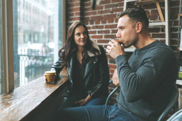 Couple having coffee in a cafe - CMSF00092