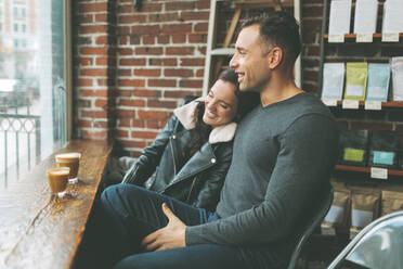 Happy couple having coffee in a cafe - CMSF00094