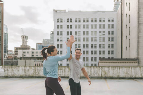Man and woman high five during a workout in the city, Vancouver, Canada stock photo