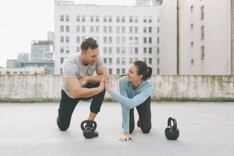 Man and woman high five while exercising in the city, Vancouver, Canada stock photo