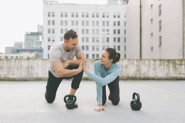 Man and woman high five while exercising in the city, Vancouver, Canada - CMSF00106