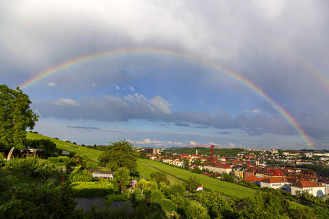 Deutschland, Bayern, Würzburg, Regenbogen über einem Weinberg am Hang, lizenzfreies Stockfoto