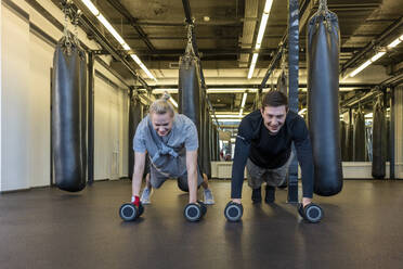 Young man and woman exercising in a gym - VPIF02067