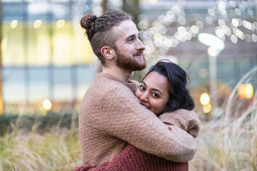 Happy affectionate couple hugging outdoors stock photo