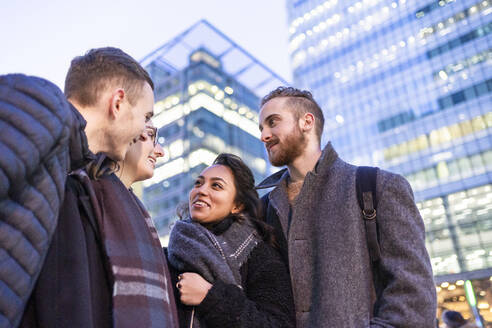 Happy friends talking in the city, London, UK - FBAF01310