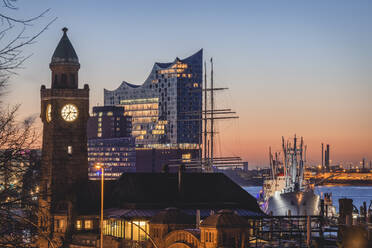 Germany, Hamburg, Landungsbrucken railroad station at dusk with Elbphilharmonie in background - KEBF01517