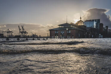 Germany, Hamburg, Sun setting over flooded fish market in Altona - KEBF01523