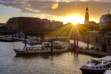 Germany, Hamburg, Boats moored in city harbor at sunset - LBF02911