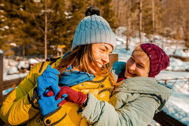 Two young women enjoying a day out in winter. - CUF54816