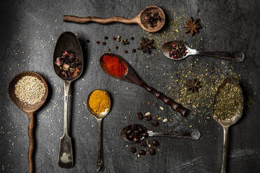 Various spices in wooden spoons on black background Stock Photo by  Prostock-studio