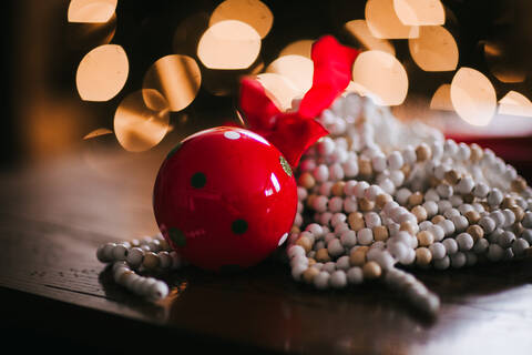 Christmas ornaments, red bell and string of beads stock photo