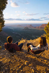 Couple admiring view over Moab, Utah, US - ISF23920