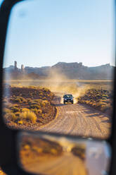 Off road vehicle driving through Valley of the Gods, Utah, US - ISF23922