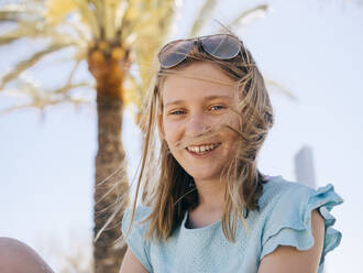 Portrait of smiling girl sitting against sky - MASF16784