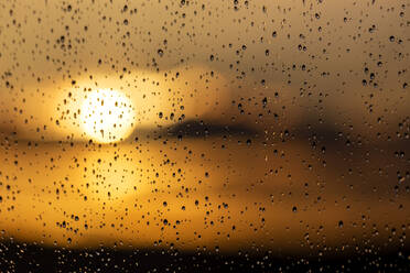 Rain drops on a window at sunset - NDF01027