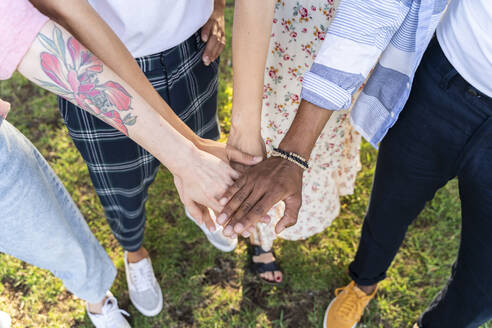 Group of friend stacking their hands - AFVF05466