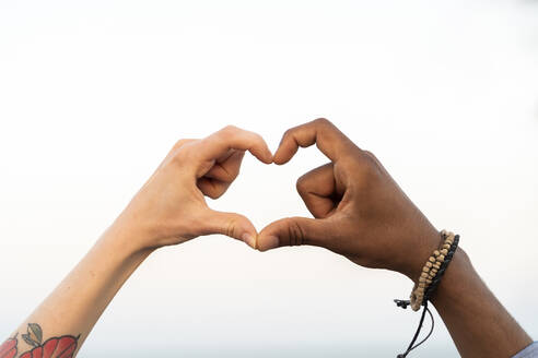 Close-up of two hands shaping a heart - AFVF05517