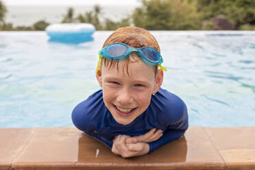 Nahaufnahme eines lächelnden Jungen, der im Schwimmbad spielt, Thailand, Asien - NMSF00406