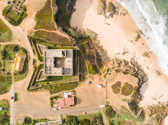 Aerial view above of Forte Pessegueiro on the shore of the beach, Sines, Portugal - AAEF06841
