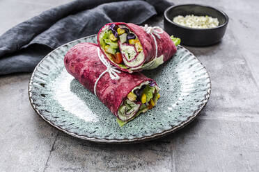 Vegetarian beetroot wraps filled with tomatoes, red cabbage, corn, iceberg lettuce, cucumbers and cream cheese - SARF04489
