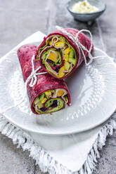 Beetroot wraps filled with ham, cheese, corn, iceberg lettuce, cucumbers and cream cheese - SARF04491