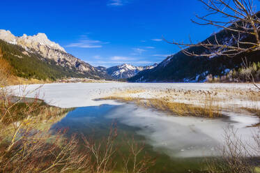 Österreich, Tirol, Ufer des zugefrorenen Haldensees - THAF02785