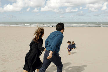 Parents and two children spending time on the beach, Scheveningen, Netherlands - OGF00167