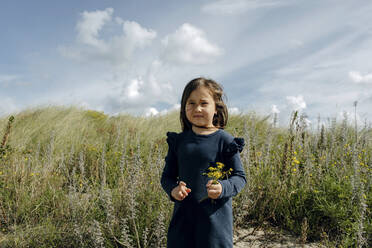 Portrait of little girl with picked flowers in the dunes, The Hague, Netherlands - OGF00174