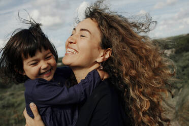 Portrait of happy mother and her little daughter in nature - OGF00180