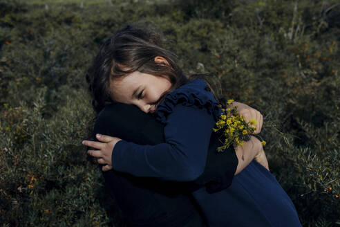 Mother and little daughter hugging each other in nature - OGF00184