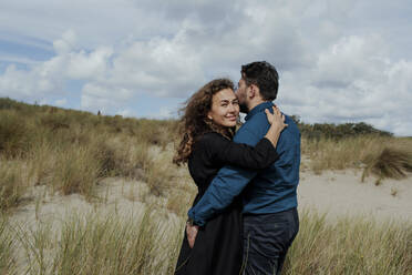 Portrait of woman hugging her husband in the dunes, The Hague, Netherlands - OGF00186